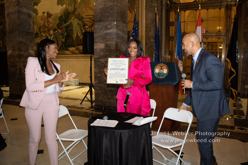 Honoree, Yandy Smith-Harris(center) Entrepreneur, TV Personality, Philanthropist and Bronx Borough President Ruben Diaz Jr.  
pose for a photo with her "Citation of Merit"